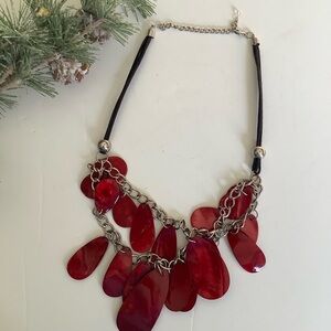 Red Necklace with oval beads up front. It has an 11” drop.